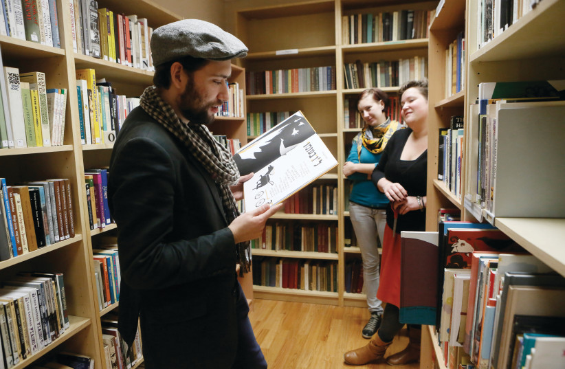 A YOUNG Polish Jew reads from a book in Yiddish, in the Jewish library at the Jewish Community Center (JCC) in Krakow. (credit: MIRIAM ALSTER/FLASH90)