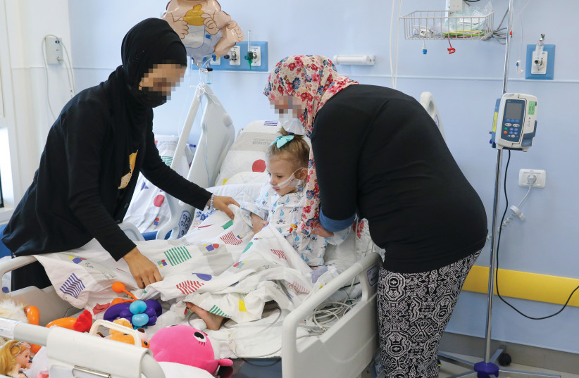   A PALESTINIAN girl from Hebron hospitalized at the Sylvan Adams Children’s Hospital at Wolfson Medical Center in Holon, after undergoing cardiac surgery. Together with her are her mother and the mother of her little roommate, also from Hebron. (credit: SAVE A CHILD'S HEART)