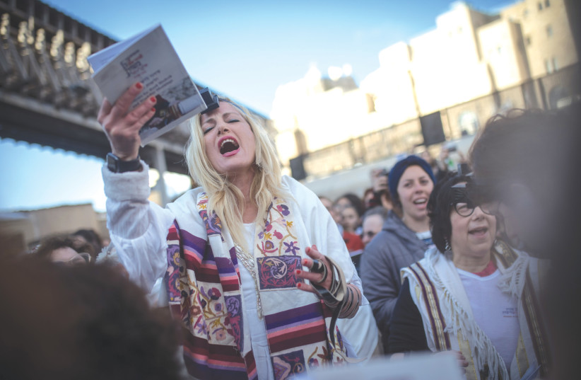  WOMEN OF THE WALL hold a prayer service at the Western Wall in Jerusalem as hundreds of ultra-Orthodox women protest (photo credit: HADAS PARUSH/FLASH90)
