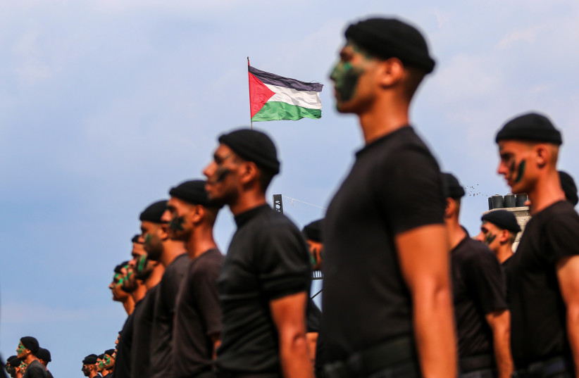   Palestinian members of the Hamas' security forces perform during their graduation ceremony in Gaza City, on September 16, 2021. 340 security personnel completed their education and are ready to work at Palestinian Ministry of Interior and National Security.  (photo credit: ATIA MOHAMMED/FLASH90)