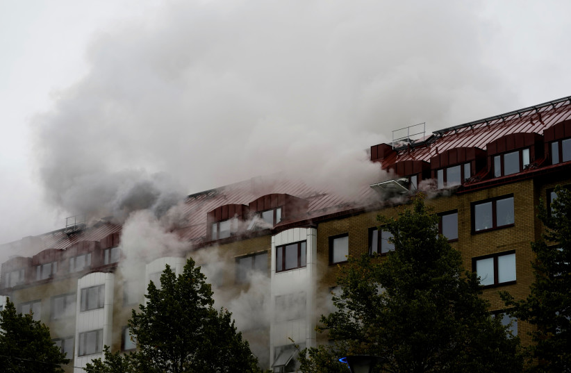 Smoke comes out of windows after an explosion hit an apartment building in Annedal, central Gothenburg, Sweden September 28, 2021. (photo credit: LARSSON ROSVALL/TT NEWS AGENCY/VIA REUTERS)