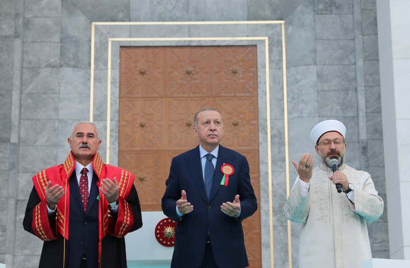  TURKISH PRESIDENT Recep Tayyip Erdogan (center) and Religious Affairs Directorate head Ali Erbas (right) pray, alongside Court of Cassation president Mehmet Akarca, at a ceremony in Ankara, September 1.  (credit: MURAT CETINMUHURDAR/PRESIDENTIAL PRESS OFFICE/HANDOUT VIA REUTERS)