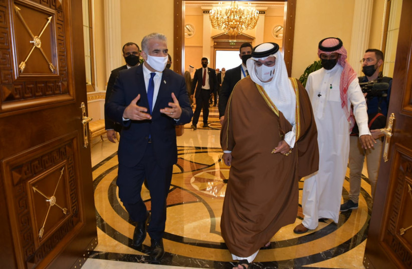 Israel's Foreign Minister Yair Lapid is seen meeting with Bahraini Crown Prince and Prime Minister Salman bin Hamad Al Khalifa in Manama in the first Israeli ministerial visit to the country, on September 30, 2021. (photo credit: SHLOMI AMSALEM/GPO)