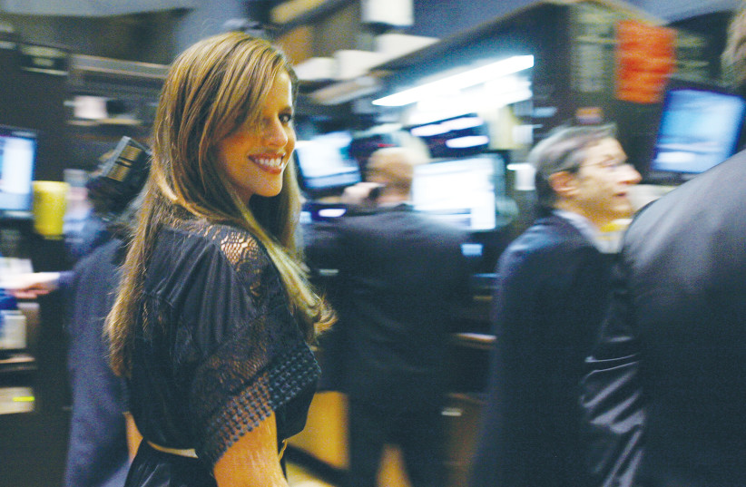 ACTRESS AND producer Noa Tishby walks the floor after ringing the opening bell at the New York Stock Exchange in 2009.  (photo credit: BRENDAN MCDERMID/REUTERS)