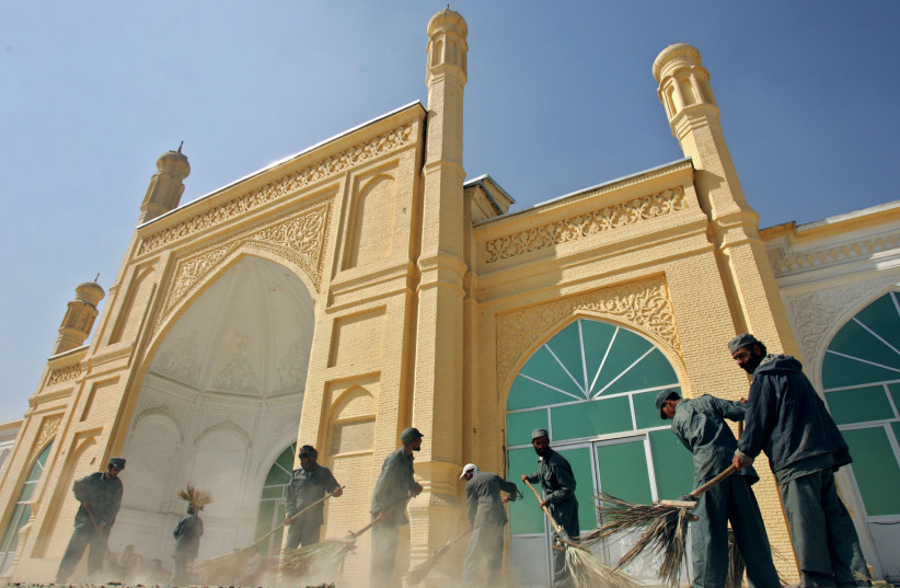 Afghan workers sweep in front of the Eidgah mosque, which is used as a polling centre for Sunday's parliamentary elections, in Kabul, Afghanistan September 17, 2005. (photo credit: REUTERS/AHMAD MASOOD)
