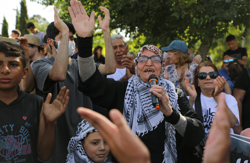  Protesters take part in a demonstration against the possible eviction of Palestinian families in Sheikh Jarrah, after an Israeli court accepted Jewish settler land claims, in east Jerusalem June 11, 2021.  (photo credit: REUTERS/AMMAR AWAD)