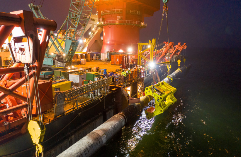  Specialists perform an above-water tie-in while finishing the construction of the Nord Stream 2 gas subsea pipeline onboard the laybarge Fortuna in the Baltic Sea, September 8, 2021. (credit: NORD STREAM 2/HANDOUT VIA REUTERS)