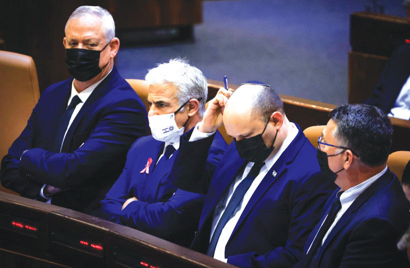  DEFENSE MINISTER Benny Gantz, Foreign Minister Yair Lapid, Prime Minister Naftali Bennett and Justice Minister Gideon Sa’ar at the opening of the winter session at the Knesset, on October 4, 2021.. (photo credit: OLIVIER FITOUSSI/FLASH90)