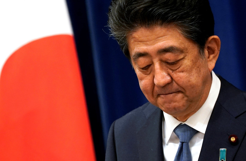  JAPANESE PRIME minister Shinzo Abe reacts during a news conference in Tokyo,  August 28. (photo credit: REUTERS/FRANK ROBICHON/POOL)
