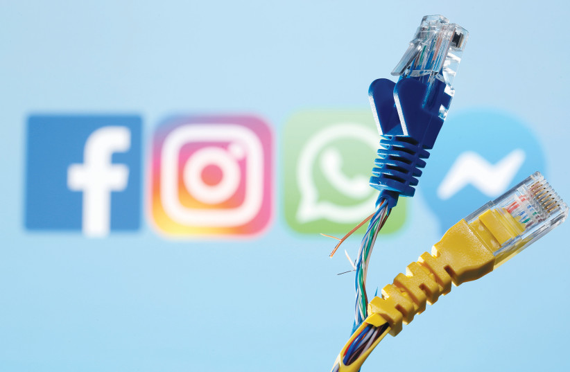  BROKEN ETHERNET CABLES are seen in front of Facebook, WhatsApp, Instagram and Messenger logos in an illustrative photo taken this week.  (credit: DADO RUVIC/REUTERS)