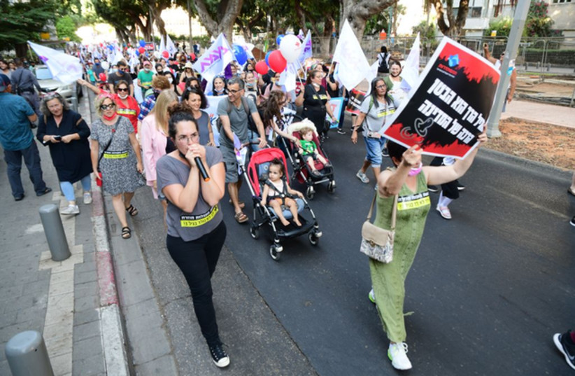  Hundreds of parents and teachers take part in a stroller march to protest low wages for daycare teachers. (photo credit: Courtesy)