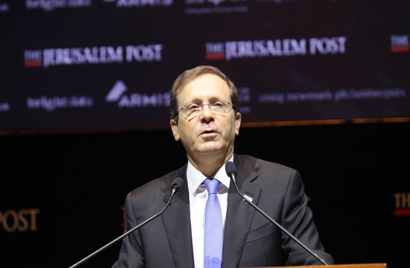  Israel's President Isaac Herzog is seen addressing the Jerusalem Post annual conference at the Museum of Tolerance in Jerusalem, on October 12, 2021. (photo credit: MARC ISRAEL SELLEM/THE JERUSALEM POST)