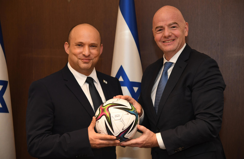  Naftali Bennett meeting with FIFA president Gianni Infantino on October 12, 2021. (photo credit: CHAIM TZACH/GPO)
