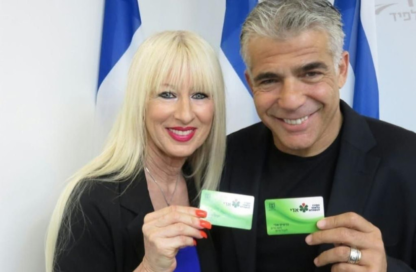  MK Merav Ben-Ari with Yesh Atid head and Foreign Minister Yair Lapid holding Adi cards (photo credit: Courtesy)