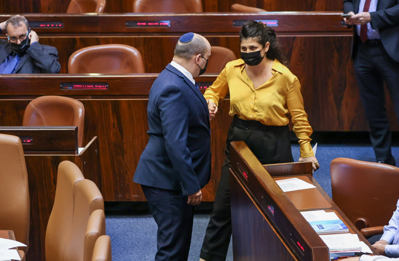 PM Naftali Bennett shakes MK Sharren Haskel's hand in the Knesset Plenum. October 13, 2021. (photo credit: NOAM MOSKOVITZ/KNESSET)