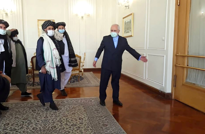  Iran's Foreign Minister Mohammad Javad Zarif meets Taliban political chief Mullah Abdul  Ghani Bardar in Tehran on Jaunary 31, 2021. (photo credit: WANA/POOL/REUTERS)
