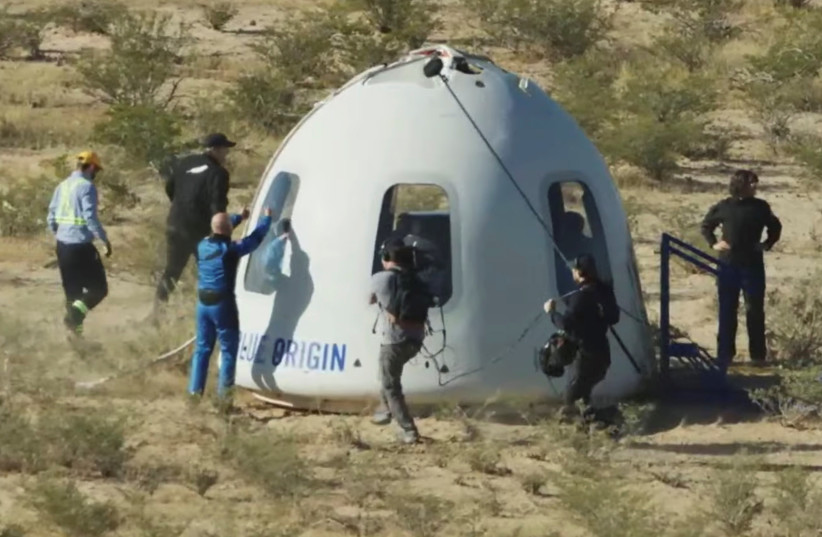  Billionaire Jeff Bezos gives a thumbs-up outside the capsule of Blue Origin's New Shepard mission NS-18, which carried ''Star Trek'' actor William Shatner and 3 other passengers on a suborbital flight, after it landed by parachute near Van Horn, Texas, US in a still image from video October 13, 202 (credit: Blue Origin/Handout via REUTERS)