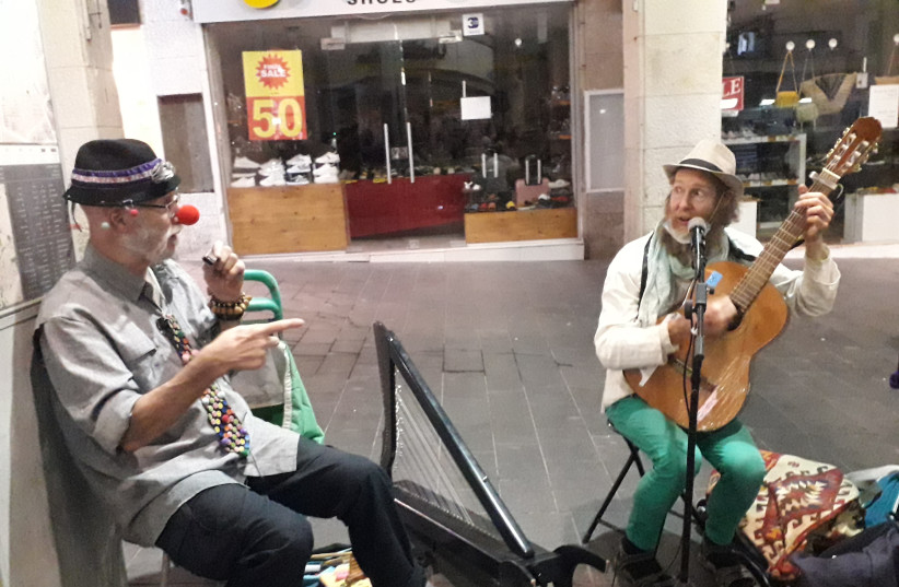  Ben Yaakov (right) playing guitar with a friend on the street. (credit: Courtesy)