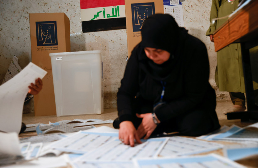  An official works at a polling station during the parliamentary election, in Baghdad, Iraq, October 10, 2021 (photo credit: REUTERS/THAIER AL-SUDANI)