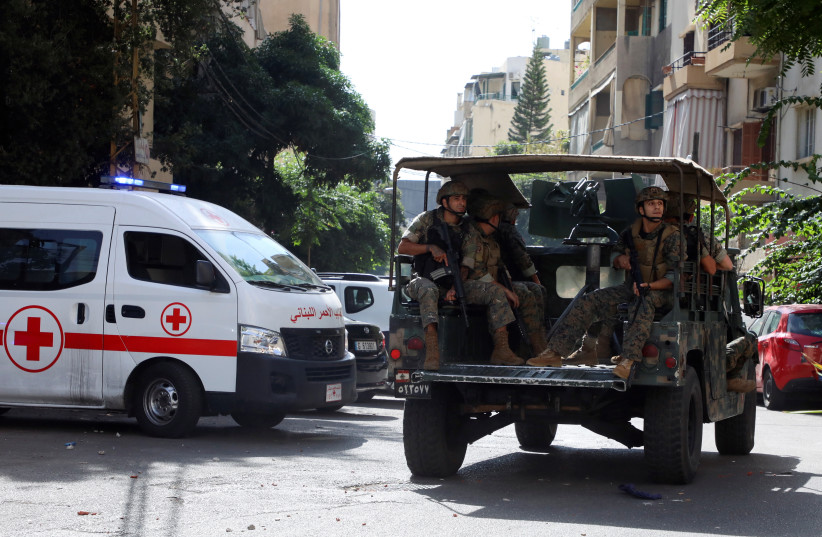  A Lebanese Red Cross vehicle is pictured as army soldiers are deployed after gunfire erupted near the site of a protest that was getting underway against Judge Tarek Bitar, who is investigating last year's port explosion, in Beirut, Lebanon October 14, 2021. (credit: REUTERS/MOHAMED AZAKIR)