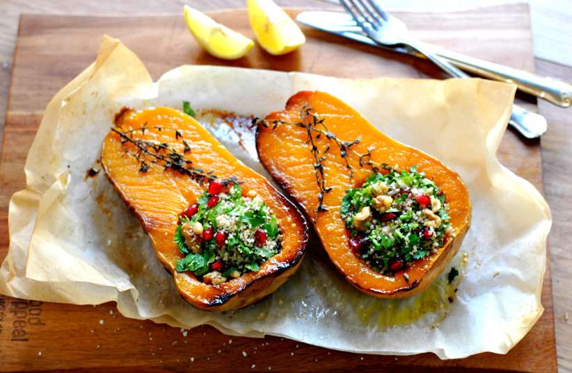  Butternut squash stuffed with herbs, couscous and pomegranate seeds. (photo credit: PASCALE PEREZ-RUBIN)