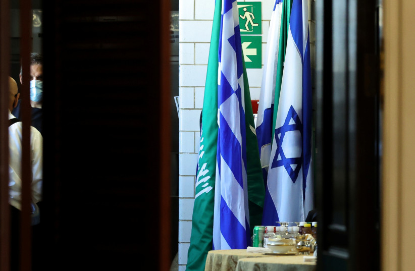  Flags of Saudi Arabia and Israel stand together in a kitchen staging area as US Secretary of State Antony Blinken holds meetings at the State Department in Washington, US, October 14, 2021.  (credit: REUTERS/JONATHAN ERNST/POOL)
