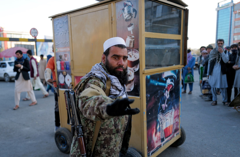  A Taliban fighter reacts to the photographer at a market in Kabul, Afghanistan, October 15, 2021.  (photo credit: REUTERS/ZOHRA BENSEMRA)
