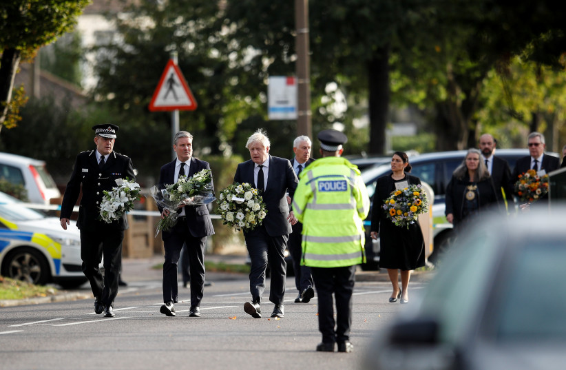  Britain's Labour Party leader Keir Starmer, Prime Minister Boris Johnson and Home Secretary Priti Patel hold flowers as they arrive at the scene where British MP David Amess was stabbed to death during a meeting with constituents at the Belfairs Methodist Church, in Leigh-on-Sea, Britain, October 1 (credit: REUTERS/PETER NICHOLLS)