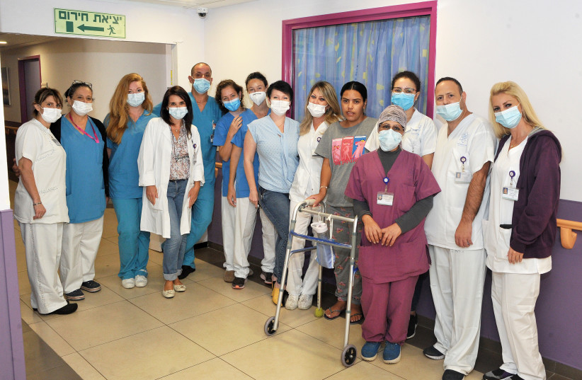  Mira Ali (in a gray shirt) with members of the Galilee Medical Center team (credit: GALILEE MEDICAL CENTER, RONI ALBERT)