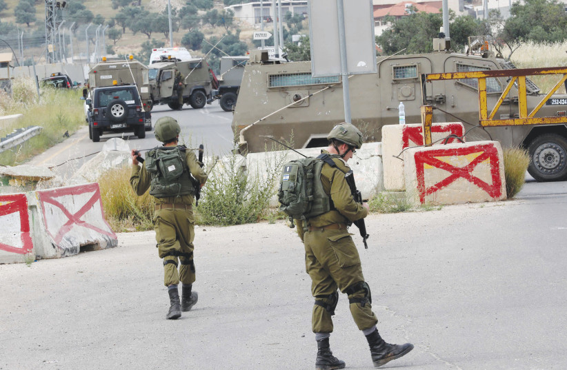  SOLDIERS ON patrol in the Hebron Hills area.  (photo credit: WISAM HASHLAMOUN/FLASH90)