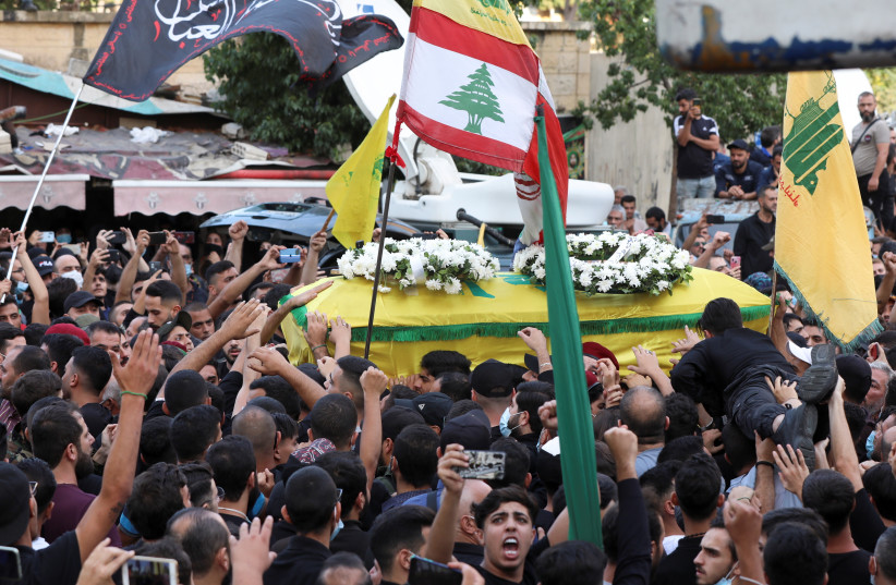  Supporters of Lebanon's Hezbollah carry a coffin of a person who was killed in violence in Beirut on Thursday, during their funeral in Beirut's southern suburbs, Lebanon (photo credit: MOHAMED AZAKIR/REUTERS)