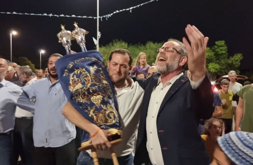  A Torah scroll in memory of Esther Horgen being carried to its permanent resting place in the settlement Tal Menashe on October 17, 2021 (credit: ROI HADI)