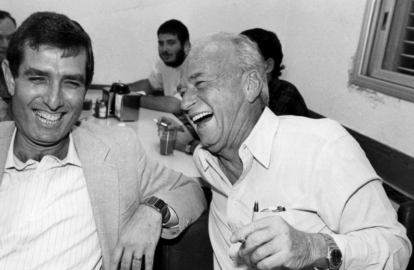  Prime Minister Yitzhak Rabin laughs together with fellow member of the political Labour party Micha Goldman at a party meeting in Tel Aviv. (photo credit: MOSHE SHAI/FLASH90)