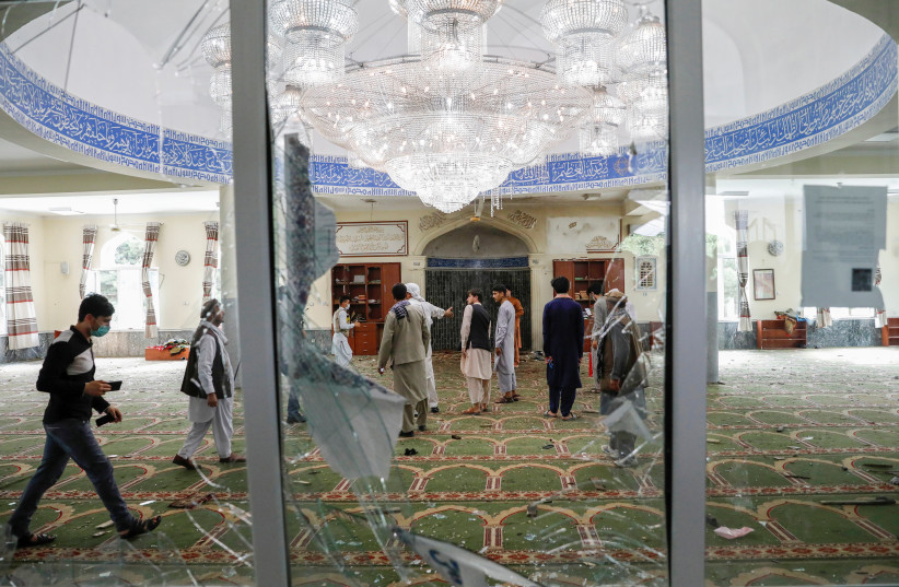  Men inspect the site of a blast inside a mosque in Kabul, Afghanistan June 12, 2020. (credit: REUTERS/MOHAMMAD ISMAIL)