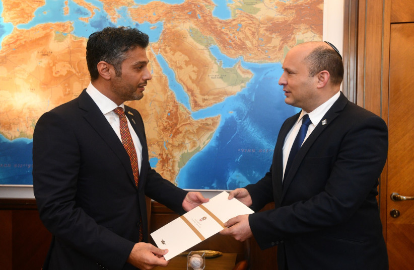  Prime Minister Naftali Bennett is seen receiving an invitation to visit the United Arab Emirates, on October 19, 2021. (photo credit: HAIM ZACH/GPO)