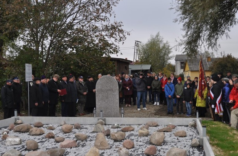 Residents of the Polish town of Wojslawice together with local leaders and representatives from the Rabbinical Commission for Cemeteries demarcate a Holocaust-era mass grave and erect a monument in their memory on Monday, Oct. 18.  (credit: Courtesy of the Municipal Authority of Wojslawice)