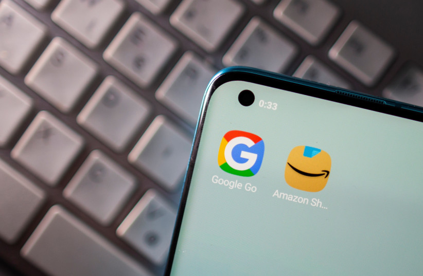  Smartphone with Google and Amazon apps are seen placed on keyboard in this illustration picture taken on June 25, 2021. (photo credit: REUTERS/DADO RUVIC/ILLUSTRATION)