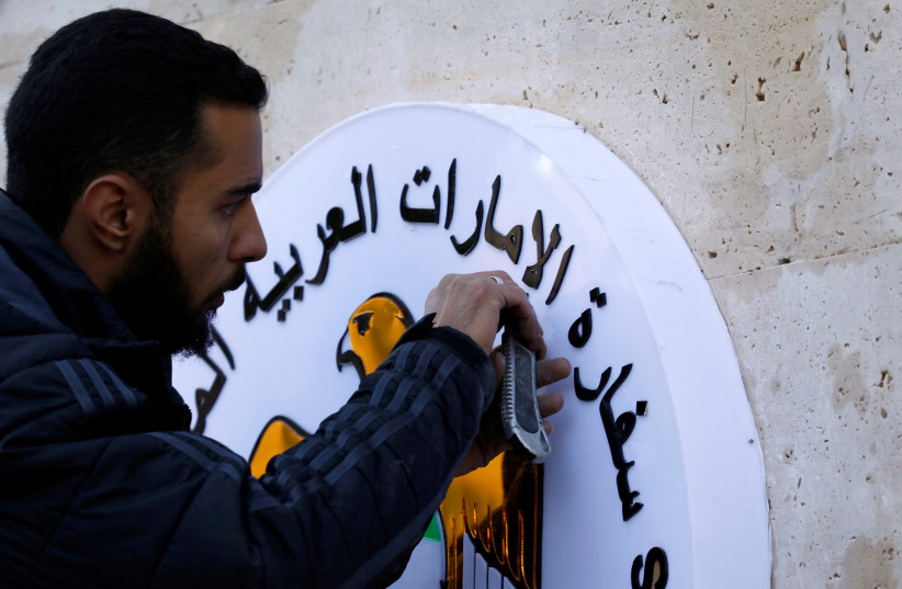  A man works on the United Arab Emirates embassy emblem during its reopening in Damascus, Syria December 27, 2018.  (credit: REUTERS/OMAR SANADIKI)