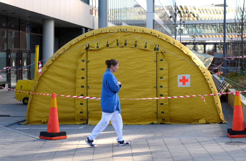  A tent is put up by the entrance to Karolinska University Hospital in Solna that prepares for new patients due to coronavirus outbreak, in Stockholm, Sweden March 19, 2020. (photo credit: ANDERS WIKLUND/TT NEWS AGENCY/VIA REUTERS)