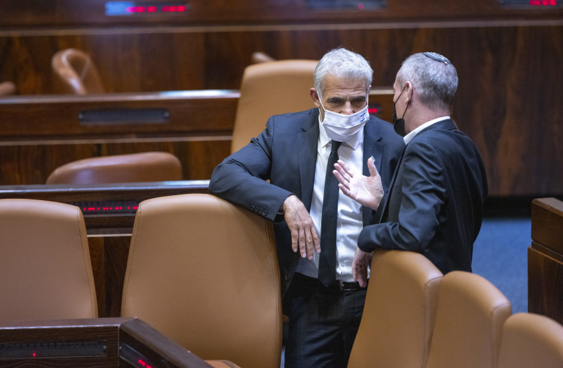  Foreign Minister Yair Lapid seen during a memorial ceremony marking 26 years since the assassination of former Israeli Prime Minister Yitzhak Rabin, at the Knesset, Israel's parliament, in Jerusalem on October 18, 2021. (photo credit: OLIVIER FITOUSSI/FLASH90)