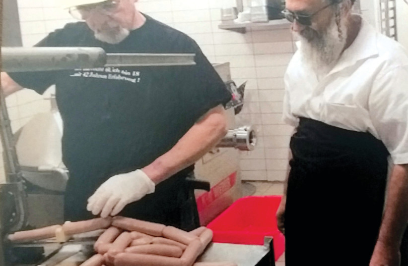  MARCEL HESS (left) and his sausages. (photo credit: STUART GHERMAN)
