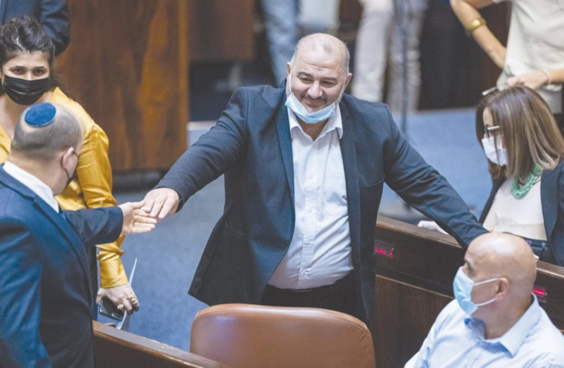 PRIME MINISTER Naftali Bennett and MK Mansour Abbas in the Knesset. This week, various members of the coalition – foremost Abbas’s Ra’am party – signaled that they may not vote for the budget if certain conditions were not met. (credit: YONATAN SINDEL/FLASH90)