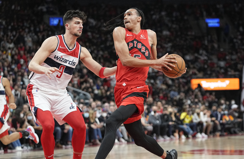  DENI AVDIJA (left) defends against Toronto Raptors’ guard Dalano Banton during the Washington Wizards’ season opener late Wednesday night. The Israeli forward had eight points and seven rebounds in the Wizards’ 98-83 victory. (photo credit: JOHN E. SOKOLOWSKI/USA TODAY SPORTS)