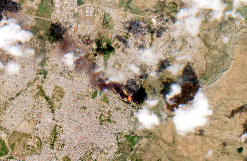 A satellite image shows smoke rising from Mekelle, Ethiopia, October 20, 2021. (photo credit: EUROPEAN UNION/COPERNICUS SENTINEL-2 IMAGERY/PROCESSED BY @defis_eu/HANDOUT VIA REUTERS)