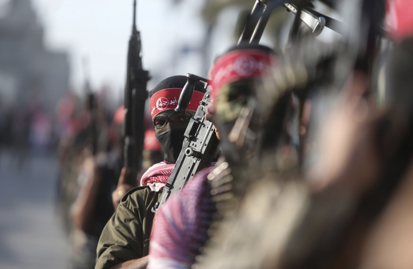  Palestinian militants from the Popular Front for the Liberation of Palestine (PFLP) take part in a military show to celebrate the 47th anniversary of the group's founding, in Khan Younis in the southern Gaza Strip December 11, 2014.  (credit: REUTERS/IBRAHEEM ABU MUSTAFA)