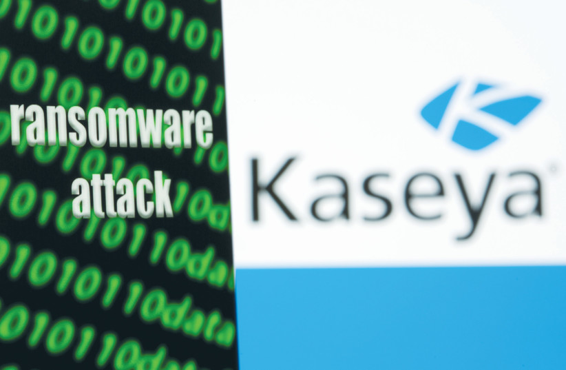 A smartphone with the words ‘Ransomware attack’ and binary code in front of the Kaseya software company logo. (photo credit: DADO RUVIC/REUTERS ILLUSTRATION)