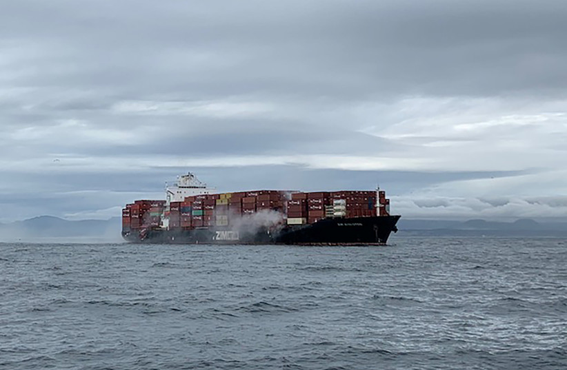 Smoke rises from the container ship Zim Kingston, burning from a fire on board, off the coast of Victoria, British Columbia, Canada October 23, 2021 (photo credit: VIA REUTERS)