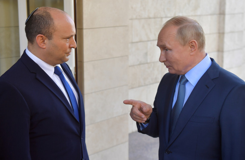  Russian President Vladimir Putin talks to Israeli Prime Minister Naftali Bennett during their meeting in Sochi, Russia October 22, 2021.  (photo credit: SPUTNIK/EVGENY VIYATO/KREMLIN VIA REUTERS)