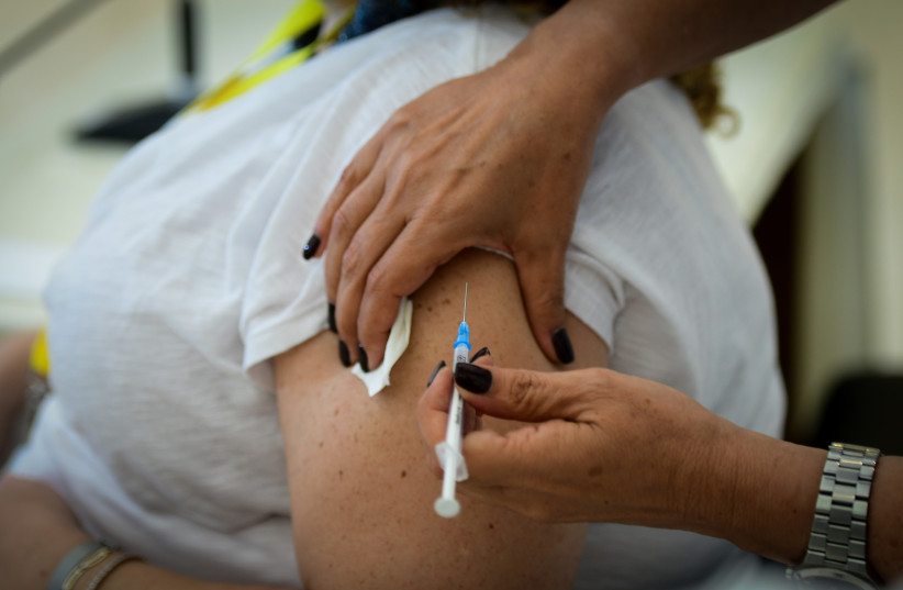  Medical staff receive their third COVID-19 vaccine shot at Meir Medical Center in Kefar Sava, August 13, 2021. (credit: AVSHALOM SASSONI/FLASH90)