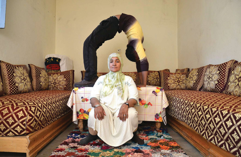 HICHAM BENOHOUD’S ‘Acrobatics’ project presents a Moroccan family living a traditional rural lifestyle while the younger members of the family gad about displaying remarkable feats of calisthenic agility. (credit: Hicham Benohoud)